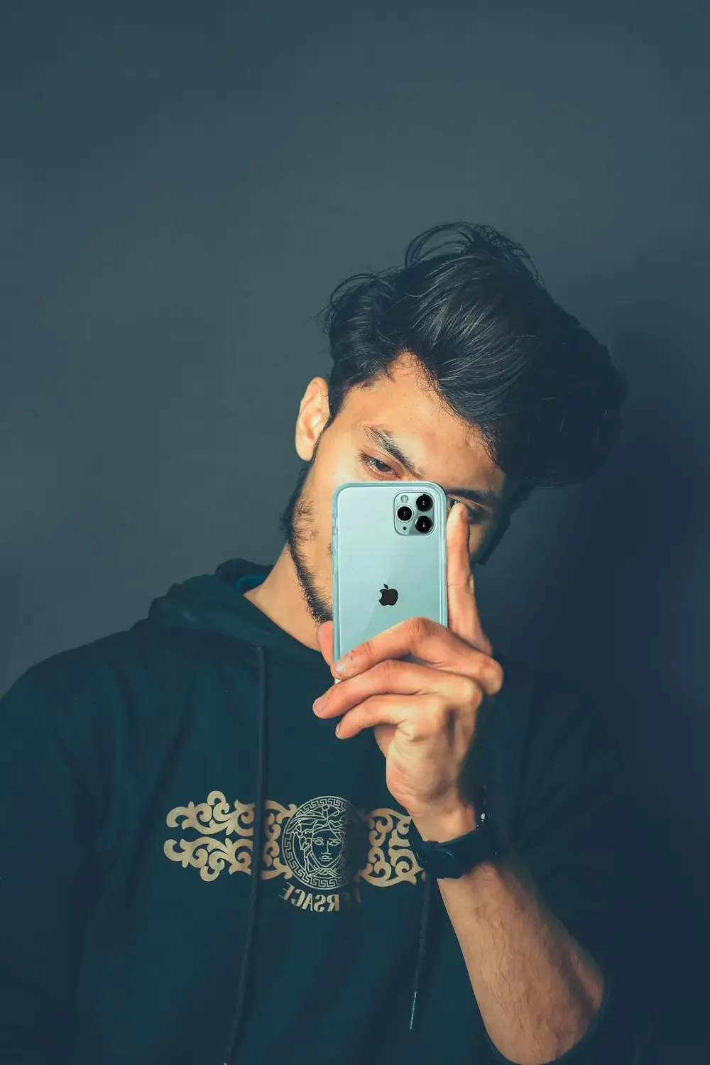 A young man taking a selfie on his phone